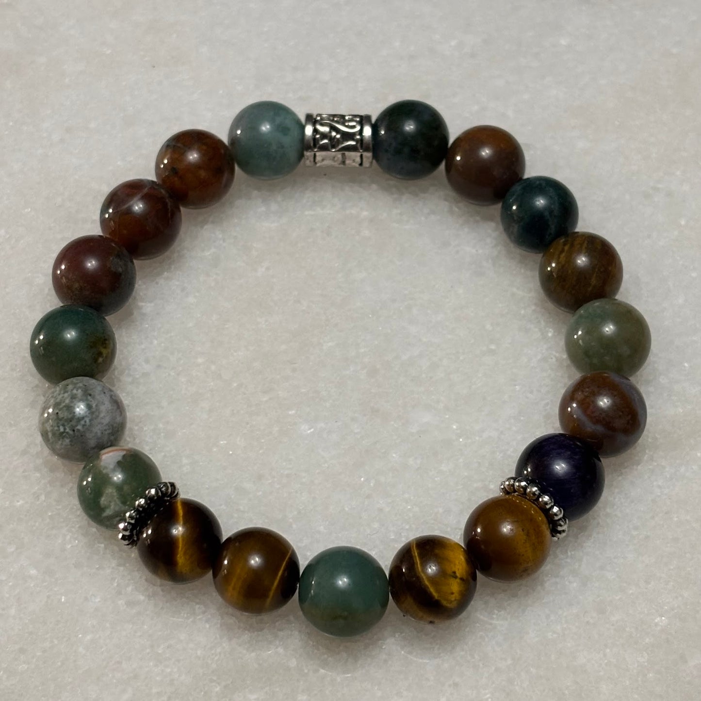 Multicolored beaded bracelet on a light gray background