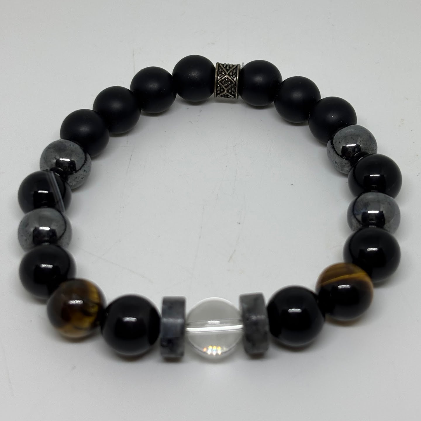 Beaded bracelet with black, gray, and brown beads on a white background