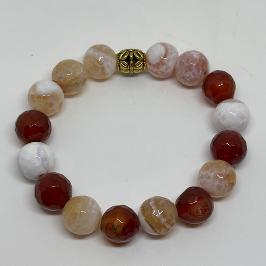 Beaded bracelet with multicolored beads and a gold clasp on a white background