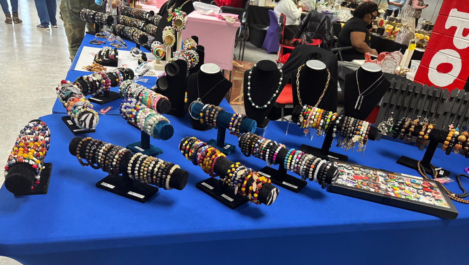 Table displaying various bracelets on stands in a store setting
