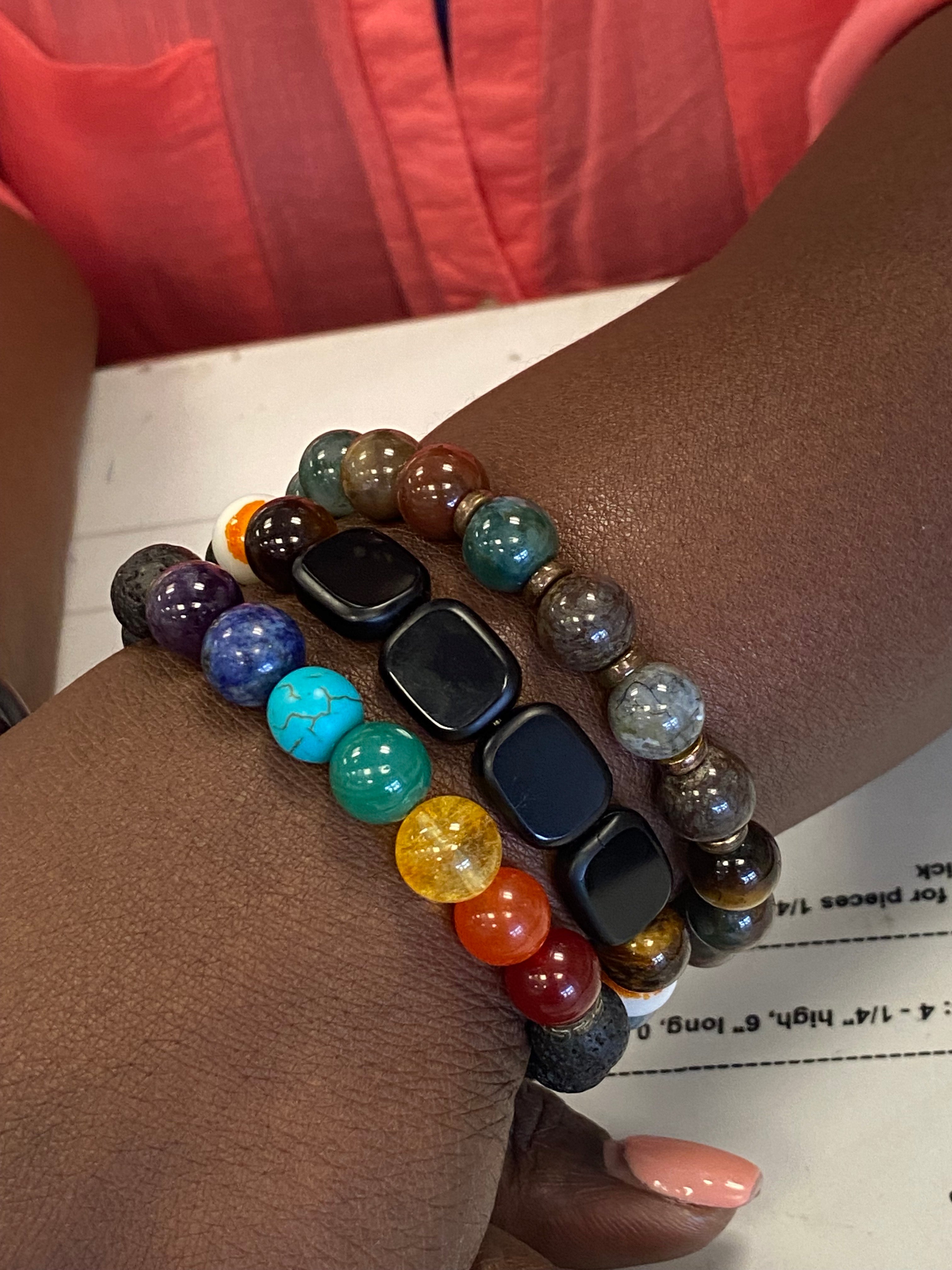 Multicolored beaded bracelets on a wrist with a blurred background