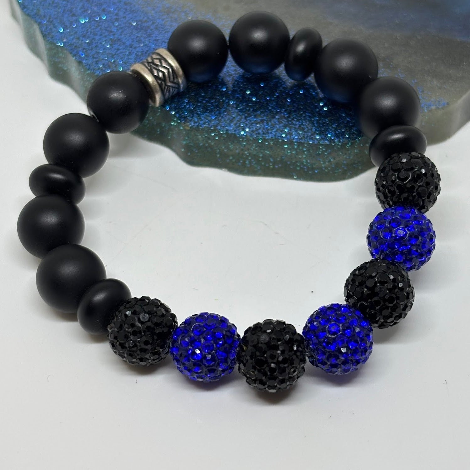 Black and blue beaded bracelet on a white background