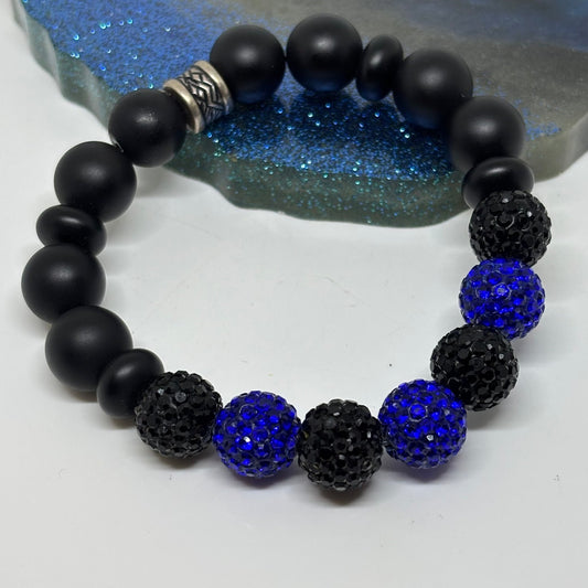 Black and blue beaded bracelet on a white background
