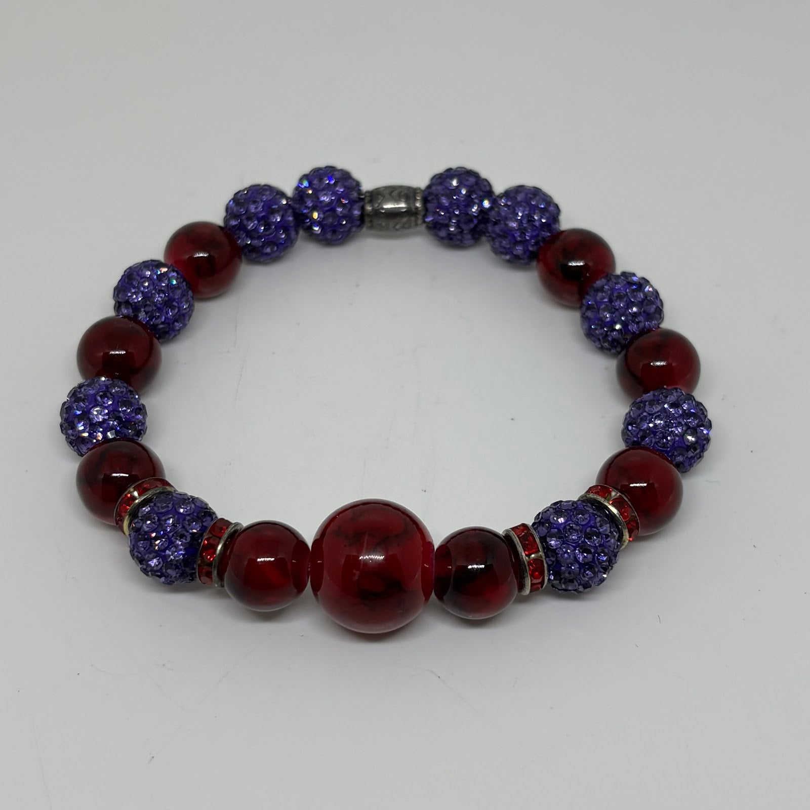 Beaded bracelet with blue and red beads on a white background