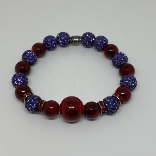 Beaded bracelet with blue and red beads on a white background