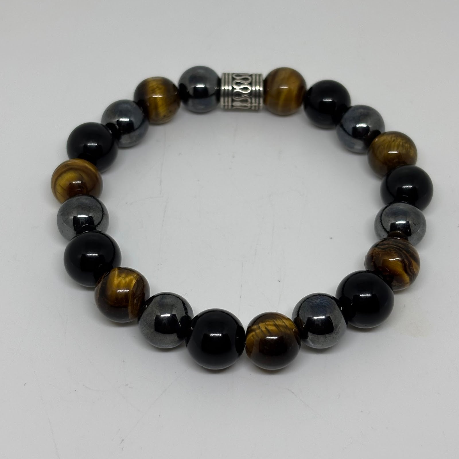 Beaded bracelet with black, brown, and gray beads on a white background